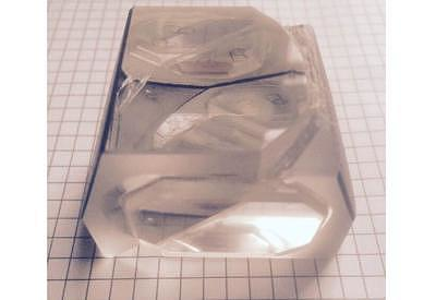 A macroscopic chamber holds a condensed photonic mesh.