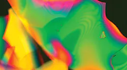 A dielectric multilayer stack coating, measuring 0.5 μm in total thickness, that has been intentionally released from the optic surface before imaging. The image was taken at 200x using a Nomarski microscope. A dielectric multilayer stack coating, measuring 0.5 μm in total thickness, that has been intentionally released from the optic surface before imaging. The image was taken at 200x using a Nomarski microscope.