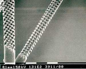 Ultraviolet (excimer) lasers are used to simultaneously drill holes in human hair by means of the mask technique.