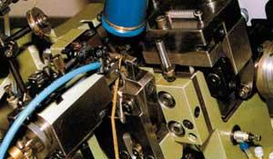 FIGURE 1. A laser welder is coupled with a high-speed chain making machine.