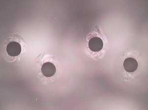 FIGURE 1. Exit holes in borosilicate glass drilled with excimer laser.