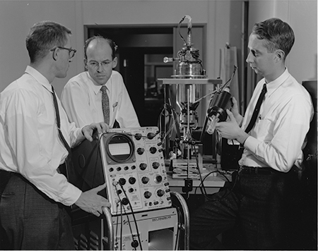 FIGURE 1. Robert N. Hall (center) with Gunther Fenner (left) and Jack Kingsley (right) at the General Electric Research & Development Center, where they made the first laser diode in 1962.