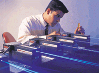 Engineer Randy Hurtado checks out single-frequency DPSS blue microlasers with 400-mW output power.