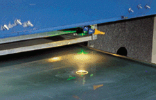 Frequency-doubled Nd:YAG laser scribes a CdTe coating on a 2 x 4-ft glass panel.