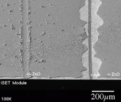 FIGURE 3. Cut on the left shows debris remaining on surface after a mechanical scribe through a 2.5-µm layer of CIGS on molybdenum (Mo) that was not carefully cleaned before being overcoated with 2.5 µm of ZnO. On the right, a 25-µm scribe in the ZnO is surrounded by a torn region 100 µm wide on each side. FIGURE 3. Cut on the left shows debris remaining on surface after a mechanical scribe through a 2.5-µm layer of CIGS on molybdenum (Mo) that was not carefully cleaned before being overcoated with 2.5 µm of ZnO. On the right, a 25-µm scribe in the ZnO is surrounded by a torn region 100 µm wide on each side.
