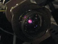 FIGURE 6. Potassium vapor in a cell is probed by ultrafast laser pulses to uncover the detailed dynamics of atomic collisions. The glowing comet-like shape seen through the entrance window of the cell is actually the atoms being excited by the pulses. FIGURE 6. Potassium vapor in a cell is probed by ultrafast laser pulses to uncover the detailed dynamics of atomic collisions. The glowing comet-like shape seen through the entrance window of the cell is actually the atoms being excited by the pulses.