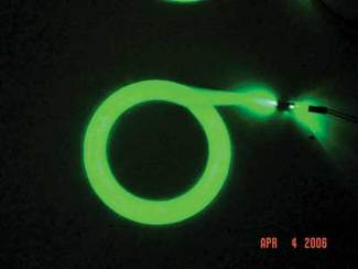 A lighting panel consists of woven plastic optical fiber (POF). In machine-vision applications, flexible curved POF panels with thin cross sections find use in conveyor or inspection systems for contoured objects.