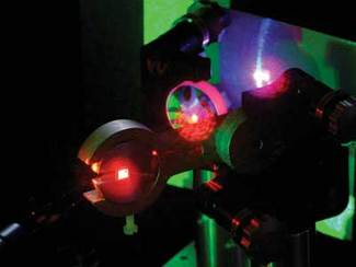 A frequency-doubled red-emitting VECSEL cavity produces tunable UV light (UV light appears bluish).