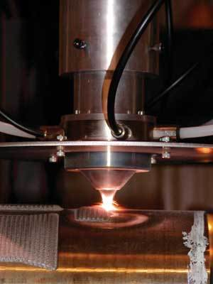 FIGURE 1. A new cladding process developed at the Fraunhofer Center for Surface and Laser Processing utilizes a 3 kW direct diode laser and a coaxial powder-feeding nozzle.