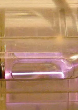 A 40 TW Ti:sapphire laser beam accelerates electrons in plasma within a capillary tube. A 40 TW Ti:sapphire laser beam accelerates electrons in plasma within a capillary tube.