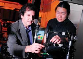A Georgia Tech research team led by Joe Perry (left), shown here with researcher Vincent Chen, has produced 3-D polymer line structures as small as 65 nm wide using new two-photon absorbing molecules.