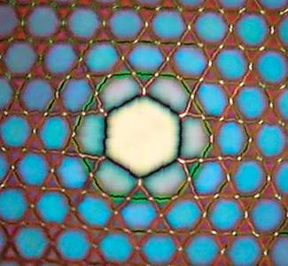 FIGURE 1. This SEM image shows the profile of the transmitted light through the Kagome-lattice hollow-core PCF. The fiber can accommodate broadband guidance in the core with a continuum of cladding modes without interaction.