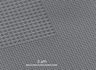 Surrounding a second-order tantalum pentoxide (Ta2O5) photonic-crystal structure with a first-order structure as shown in this micrograph reduces light losses from the device. A section of one of the four corners of the device without gain material is shown here.