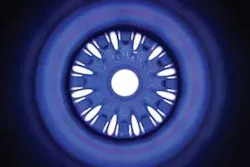 FIGURE 4. Twelve pulsed lamps and a diffuse reflector surround a 32-mm-diameter Nd:glass laser rod, one of 192 preamplifier modules that will provide the light for inertial-confinement fusion reactions at NIF. When fired, each of the 12 lamps can deliver in excess of 1 kJ of pump light to the rod. The rod is used in a four-pass amplifier configuration, boosting pulses from the millijoule regenerative amplifier to the multijoule level. FIGURE 4. Twelve pulsed lamps and a diffuse reflector surround a 32-mm-diameter Nd:glass laser rod, one of 192 preamplifier modules that will provide the light for inertial-confinement fusion reactions at NIF. When fired, each of the 12 lamps can deliver in excess of 1 kJ of pump light to the rod. The rod is used in a four-pass amplifier configuration, boosting pulses from the millijoule regenerative amplifier to the multijoule level.