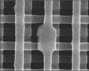 FIGURE 1. A 0.3-&micro;m2 defect in a 3-D multiple-quantum-well photonic crystal serves as a cavity that emits 1550-nm light.
