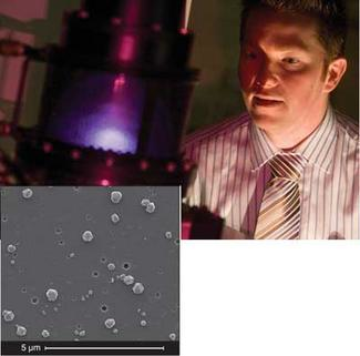 Materials Engineer David Simpson from Quantum Communications Victoria (QCV) observes the growth of diamond nanocrystals in a microwave plasma-enhanced chemical-vapor-deposition reactor. A patented technique for optical pumping of single-atom nitrogen defects in the diamond nanocrystals (inset) creates an excited state that generates single-photon emission at 700 nm, allowing show-floor operation of QCV&rsquo;s newly released SPS 1.01 single-photon source.