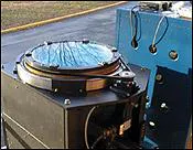 FIGURE 2. The HARLIE transceiver contains an optical -element that is a 40-cm-diameter transmission HOE with a 1-m focal length. The HOE appears on the top of the black transceiver on the left, which also contains the laser and the detector on the bottom. FIGURE 2. The HARLIE transceiver contains an optical -element that is a 40-cm-diameter transmission HOE with a 1-m focal length. The HOE appears on the top of the black transceiver on the left, which also contains the laser and the detector on the bottom.