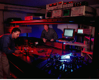 Eric Wachter (left), chief scientist at Photogen Technologies (Knoxville, TN), and Walt Fisher, another Photogen researcher, prepare to test a new feature of the company`s two-photon technology that uses a proprietary software program to position the laser and move its focal point within a defined three-dimensional tissue space. The system is being developed for use in the treatment of melanoma and other cancers.