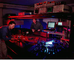 Eric Wachter (left), chief scientist at Photogen Technologies (Knoxville, TN), and Walt Fisher, another Photogen researcher, prepare to test a new feature of the company`s two-photon technology that uses a proprietary software program to position the laser and move its focal point within a defined three-dimensional tissue space. The system is being developed for use in the treatment of melanoma and other cancers. Eric Wachter (left), chief scientist at Photogen Technologies (Knoxville, TN), and Walt Fisher, another Photogen researcher, prepare to test a new feature of the company`s two-photon technology that uses a proprietary software program to position the laser and move its focal point within a defined three-dimensional tissue space. The system is being developed for use in the treatment of melanoma and other cancers.