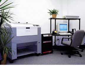 A PolyScience chiller provides up to 2500 W of heat-removal capacity to the Epilog Radius Laser Engineering and Cutting system. The chiller is shown installed to the right of the Epilog system, which continuously produces prototypes and production pieces.