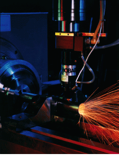 High-speed end effector uses capacitive height sensing and an independent axis to maintain proper nozzle-to-workpiece position for cutting with an industrial Nd:YAG laser.