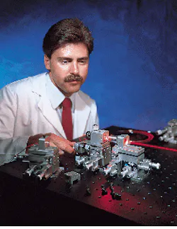 FIGURE 2. Precision stages and accessories designed for fiber alignment facilitate modular construction of many measurement and alignment applications. Here a researcher couples a free-space laser into a fiber to determine its optical characteristics. FIGURE 2. Precision stages and accessories designed for fiber alignment facilitate modular construction of many measurement and alignment applications. Here a researcher couples a free-space laser into a fiber to determine its optical characteristics.