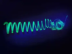 An extruded spiral made of polymer-coated silicon nanosheets glows in UV light. An extruded spiral made of polymer-coated silicon nanosheets glows in UV light.