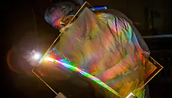 Marcus Monticelli inspects the anti-reflective coating on a National Ignition Facility grating debris shield. The coating restores lost NIF energy and eliminates a source of optics damage. Marcus Monticelli inspects the anti-reflective coating on a National Ignition Facility grating debris shield. The coating restores lost NIF energy and eliminates a source of optics damage.