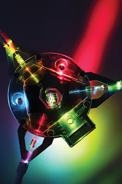 An example of a complex assembly for visible light applications with a triangular-shaped fused silica PIC. An example of a complex assembly for visible light applications with a triangular-shaped fused silica PIC.