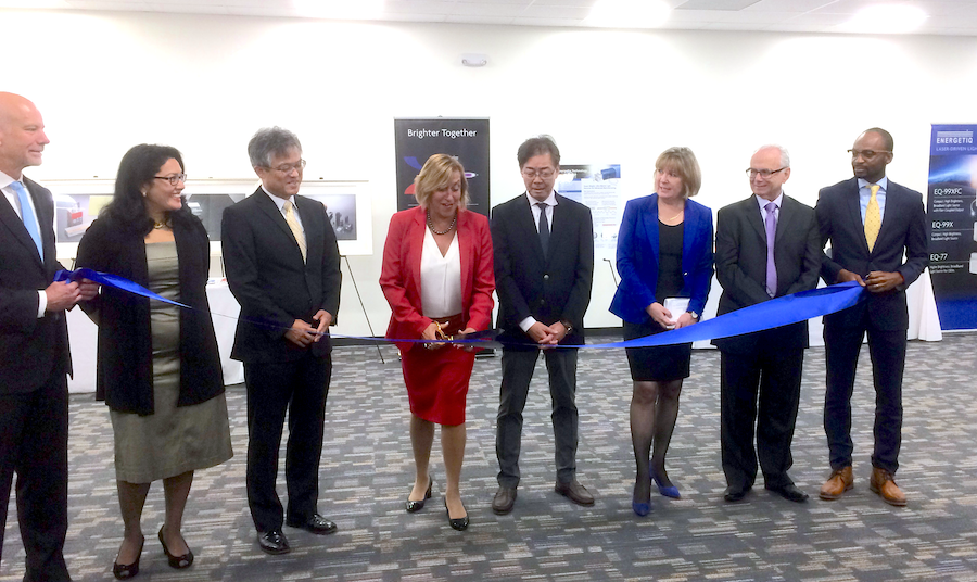 As representatives of Energetiq Technology and Hamamatsu (which acquired Energetiq in 2017) look on, Debbie Gustafson, CEO of Energetiq, cuts the ribbon in the grand opening ceremony for the company's new facility in Wilmington, MA.