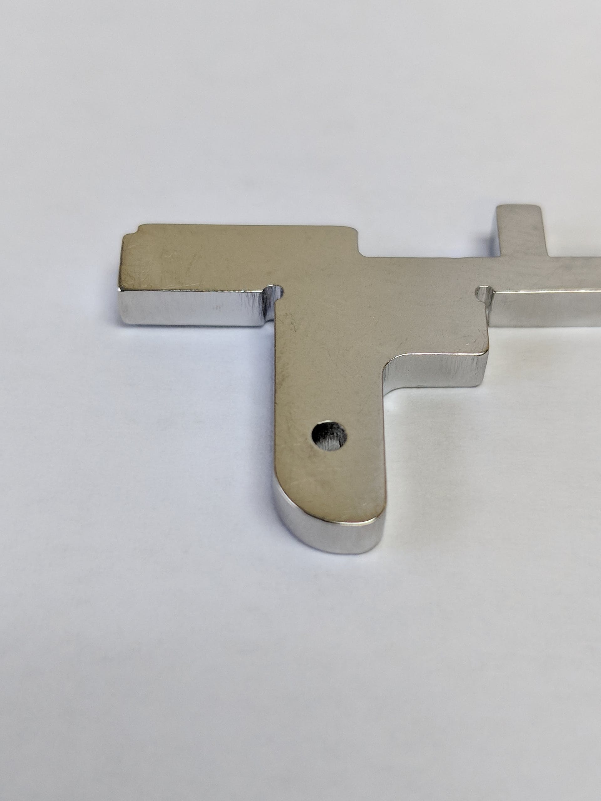 FIGURE 1. A 0.063-in.-diameter hole produced to a tolerance of &PlusMinus;0.001 in. and with smaller corner reliefs is shown.