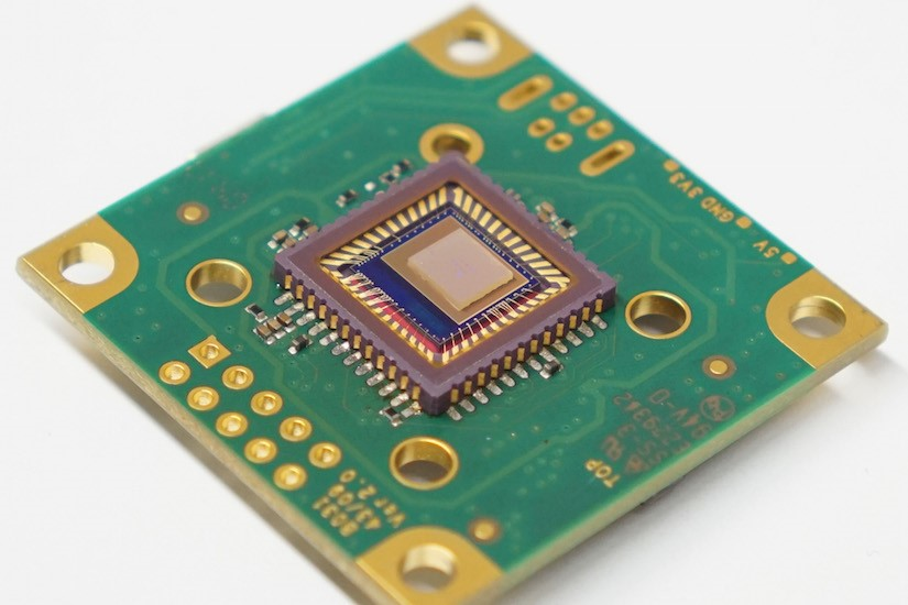 This compact and low-cost spectrometer could help turn ordinary cell phones into advanced analytical tools; at the center of the device, a 210-&micro;m-square photonic-crystal slab sits atop a camera sensor.