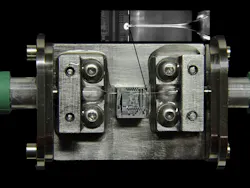 FIGURE 2. Optics from Chiral Photonics are combined with OpSIS Foundry (University of Delaware; Newark, DE) photonic integrated-circuit technology to form a complete optoelectronics package with ultradense, low-insertion-loss optical I/O. FIGURE 2. Optics from Chiral Photonics are combined with OpSIS Foundry (University of Delaware; Newark, DE) photonic integrated-circuit technology to form a complete optoelectronics package with ultradense, low-insertion-loss optical I/O.