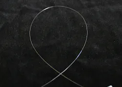 Unclad Yb:YAG single-crystal fiber (SCF) has a diameter of only 100 μm and demonstrates pure waveguided laser operation. Unclad Yb:YAG single-crystal fiber (SCF) has a diameter of only 100 μm and demonstrates pure waveguided laser operation.