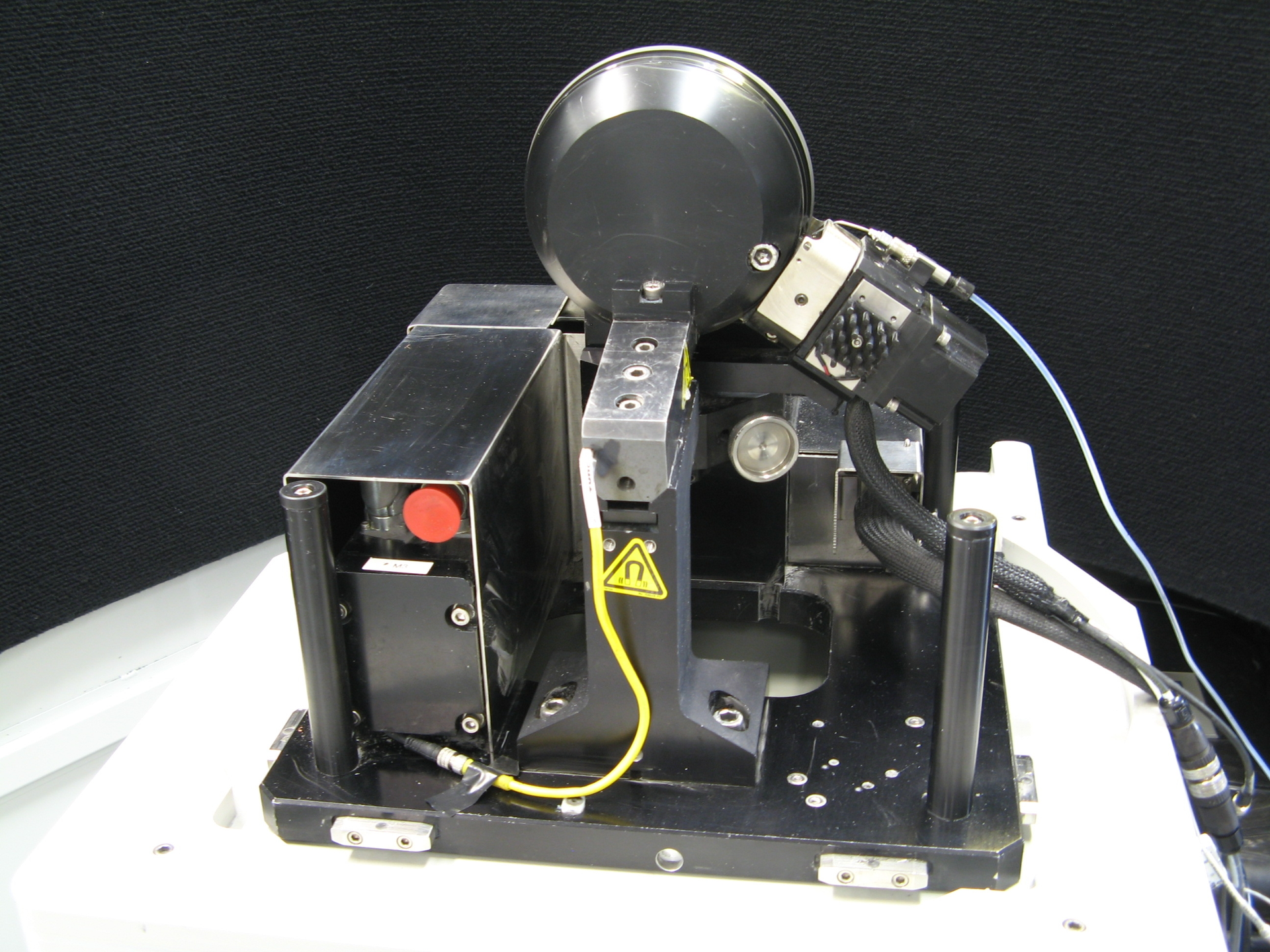 A miniature MRF polishing head with an improved fluid-delivery system is small enough to fit on an end table. The polishing wheel is at the top; the ribbon of MR fluid is held on the wheel&rsquo;s rim.