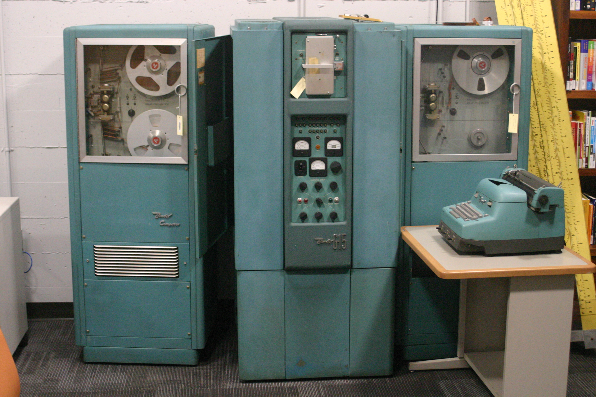 FIGURE 1. Bendix G15 was an early vacuum tube computer with 450 vacuum tubes and 300 germanium diodes. The main unit is in the middle; tape drives are to the sides. Control was through the digital typewriter at right.