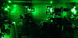 An image from an experiment in the quantum optics laboratory at the University of Cambridge demonstrates how laser light was used to excite artificially constructed atoms known as quantum dots to create the “squeezed” single photons. An image from an experiment in the quantum optics laboratory at the University of Cambridge demonstrates how laser light was used to excite artificially constructed atoms known as quantum dots to create the “squeezed” single photons.