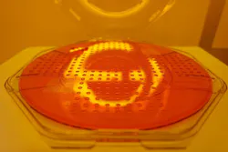 FIGURE 6. 200 mm photoresist master substrate for wafer-level optics carrying 250 Fresnel lenslets. FIGURE 6. 200 mm photoresist master substrate for wafer-level optics carrying 250 Fresnel lenslets.