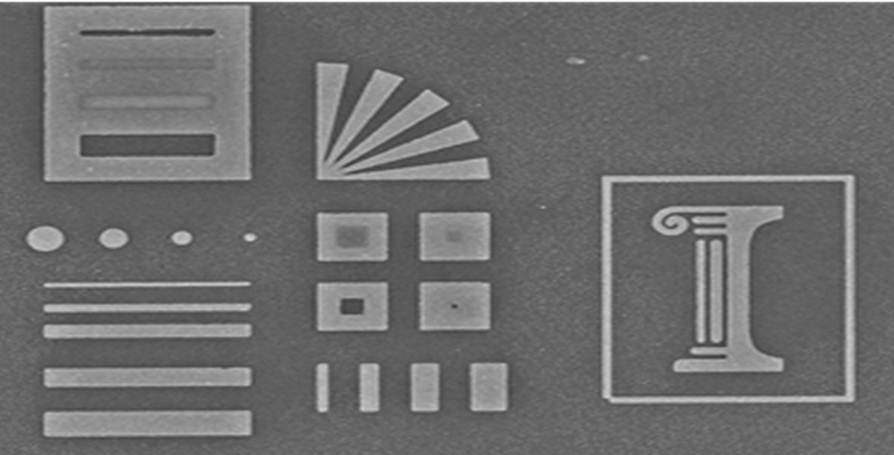 A glass stamp reproduces precise, nanometer-scale etchings in silver. The original engraving is 10 microns wide.
