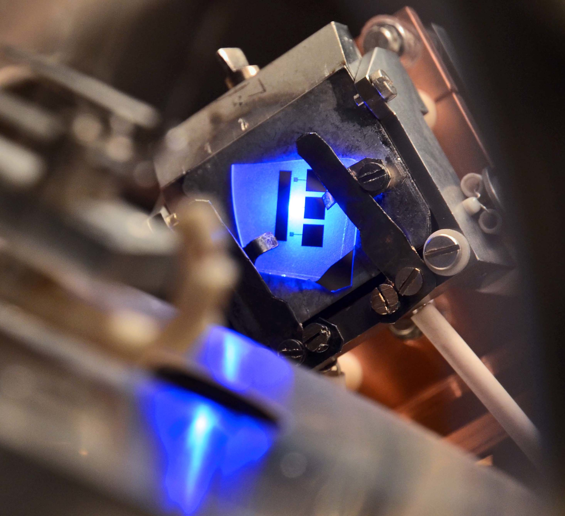 FIGURE 1. An LED emitting light under forward bias in an ultrahigh-vacuum chamber shows simultaneous electron-emission energy, revealing that Auger recombination is behind efficiency droop in GaN-based LEDs.