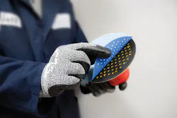 FIGURE 1. A laser-cut, multi-hole abrasive disc is attached to a backup pad for use on a dual-action pneumatic sander. FIGURE 1. A laser-cut, multi-hole abrasive disc is attached to a backup pad for use on a dual-action pneumatic sander.