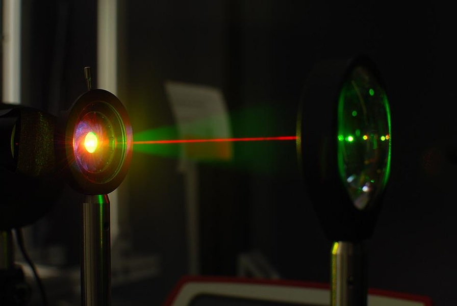 A laser beam is used in the lab to test the gold-hyperdoped sample of silicon to confirm its infrared-sensitive properties.