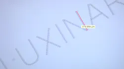 FIGURE 1. Subsurface marking in glass, with characters less than 0.5 mm high, is possible with femtosecond laser sources. FIGURE 1. Subsurface marking in glass, with characters less than 0.5 mm high, is possible with femtosecond laser sources.