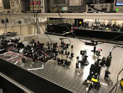 FIGURE 2. This image shows the erbium-fiber-based dual-comb system and experimental setup Wright used to demonstrate her technique. FIGURE 2. This image shows the erbium-fiber-based dual-comb system and experimental setup Wright used to demonstrate her technique.