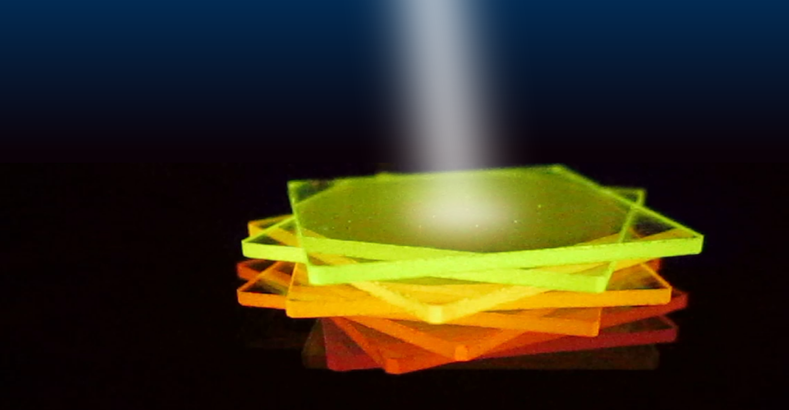 FIGURE 2. The active film for the novel sensor concept is only as thick as a human hair; here, processed on thin glass substrates, it exhibits a wavelength-dependent luminescence.
