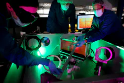 (L-R) Laser engineer Lauren Weinberg, research scientist John Nees, and research engineer Galina Kalinchenko pose for photos while working on the ZEUS laser at the NSF ZEUS laser facility in a Michigan Engineering lab. (L-R) Laser engineer Lauren Weinberg, research scientist John Nees, and research engineer Galina Kalinchenko pose for photos while working on the ZEUS laser at the NSF ZEUS laser facility in a Michigan Engineering lab.