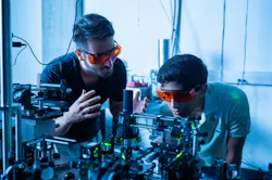 FIGURE 1. Kamyar Parto (left) works in the Moody Quantum Photonics Lab with Arjun Choudhri, a high school student he mentored last summer. FIGURE 1. Kamyar Parto (left) works in the Moody Quantum Photonics Lab with Arjun Choudhri, a high school student he mentored last summer.