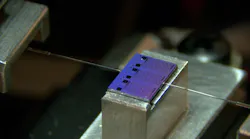 A passive chip from one of the AIM Photonics PIC Kits being optically characterized at Bridgewater State University in Massachusetts. A passive chip from one of the AIM Photonics PIC Kits being optically characterized at Bridgewater State University in Massachusetts.