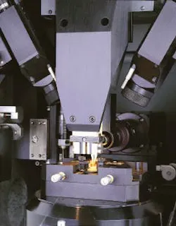 Microwelding workstation uses pulsed 50-W Nd:YAG laser with multibeam fiberoptic-beam-delivery system to attach fiber to a 980-nm pump laser diode 'butterfly' package. Fiber is held in place by upper tweezers. Microwelding workstation uses pulsed 50-W Nd:YAG laser with multibeam fiberoptic-beam-delivery system to attach fiber to a 980-nm pump laser diode 'butterfly' package. Fiber is held in place by upper tweezers.