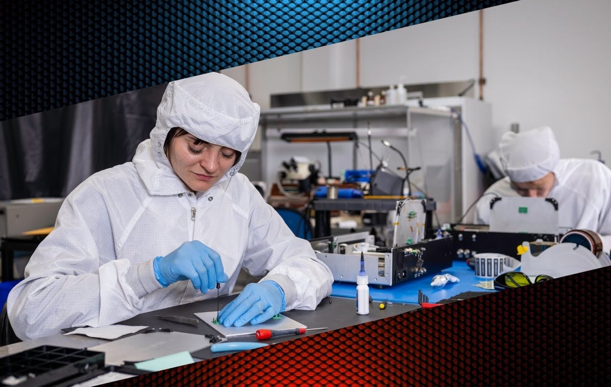 FIGURE 1. Vescent&rsquo;s team in the cleanroom assembling frequency combs.